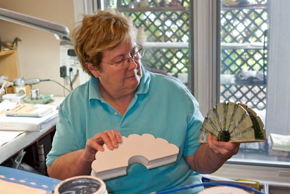 Shirley with her new vase design for stem cut flowers.